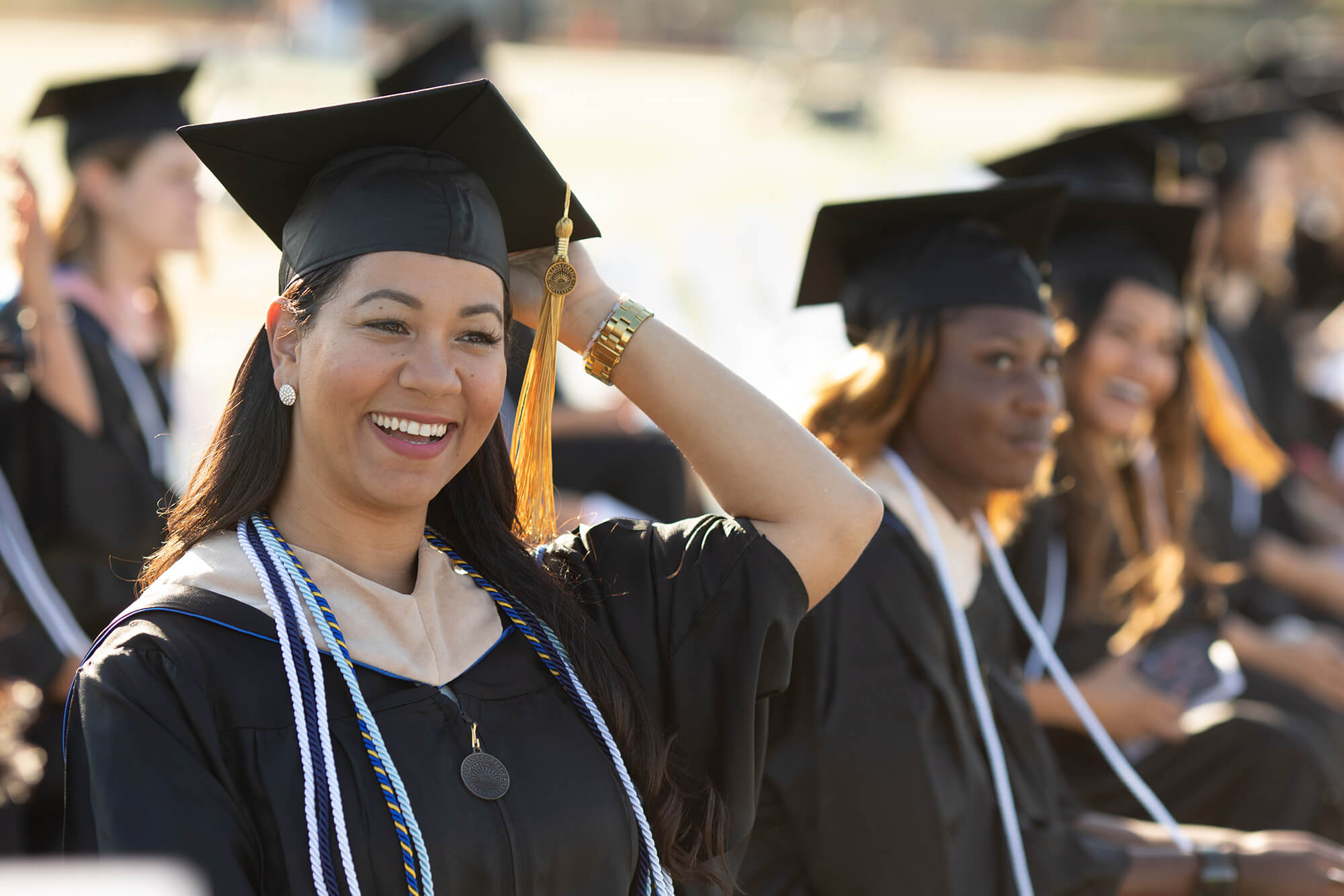 A student smiles during a Rollins College commencement ceremony.
