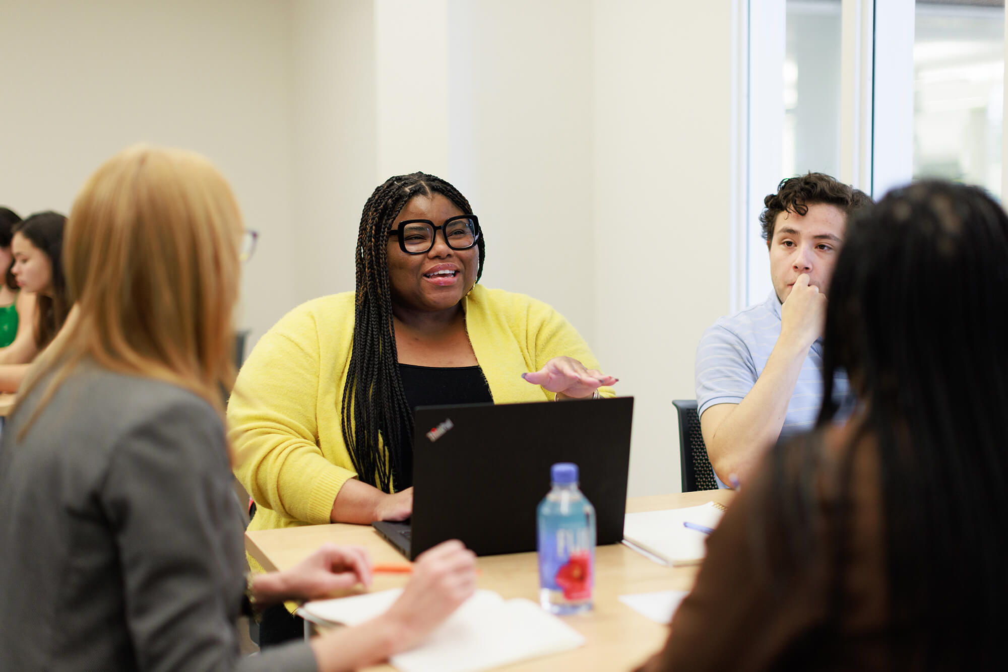 A communications students works in a small group.