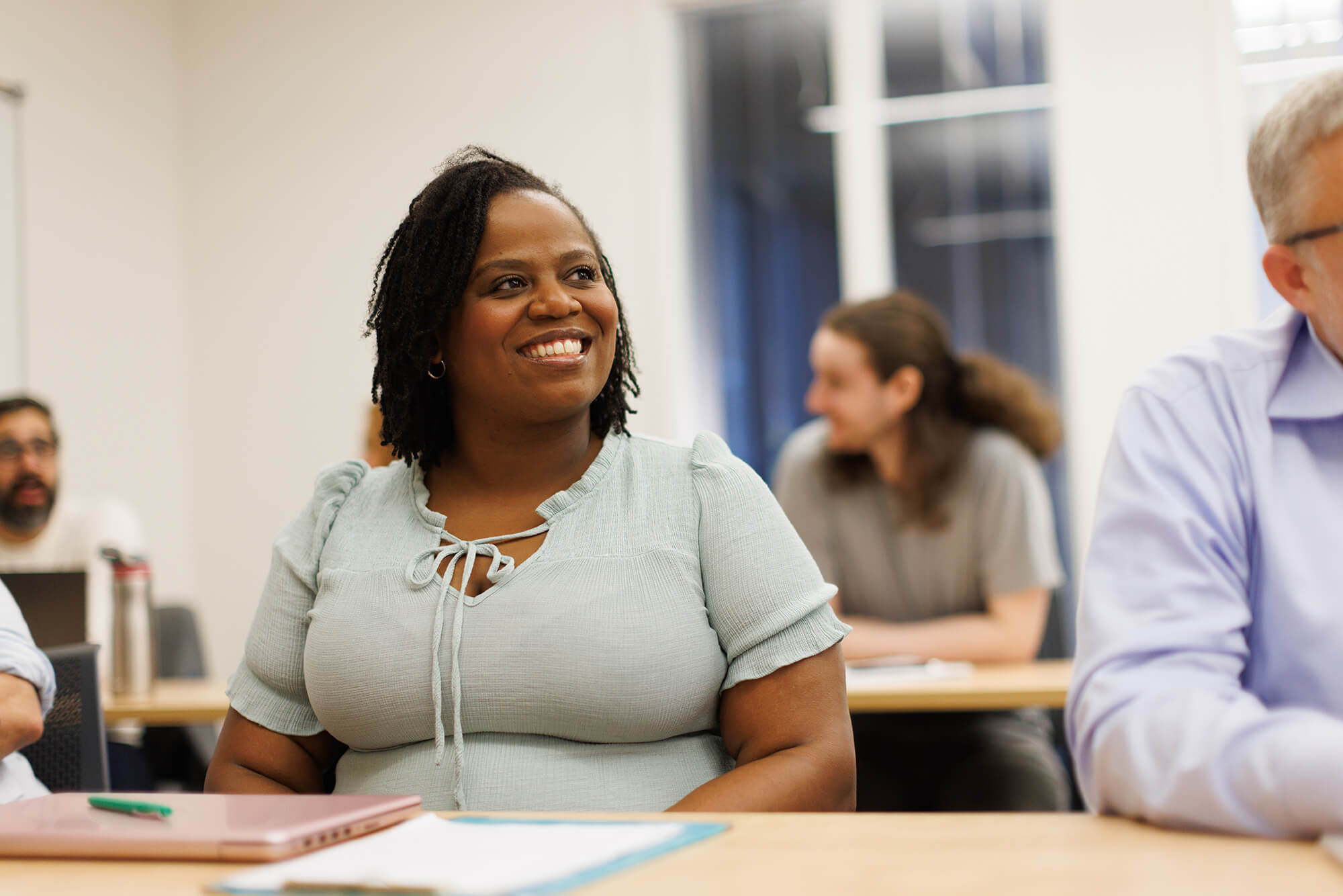 A student smiles during a graduate class at Rollins college.