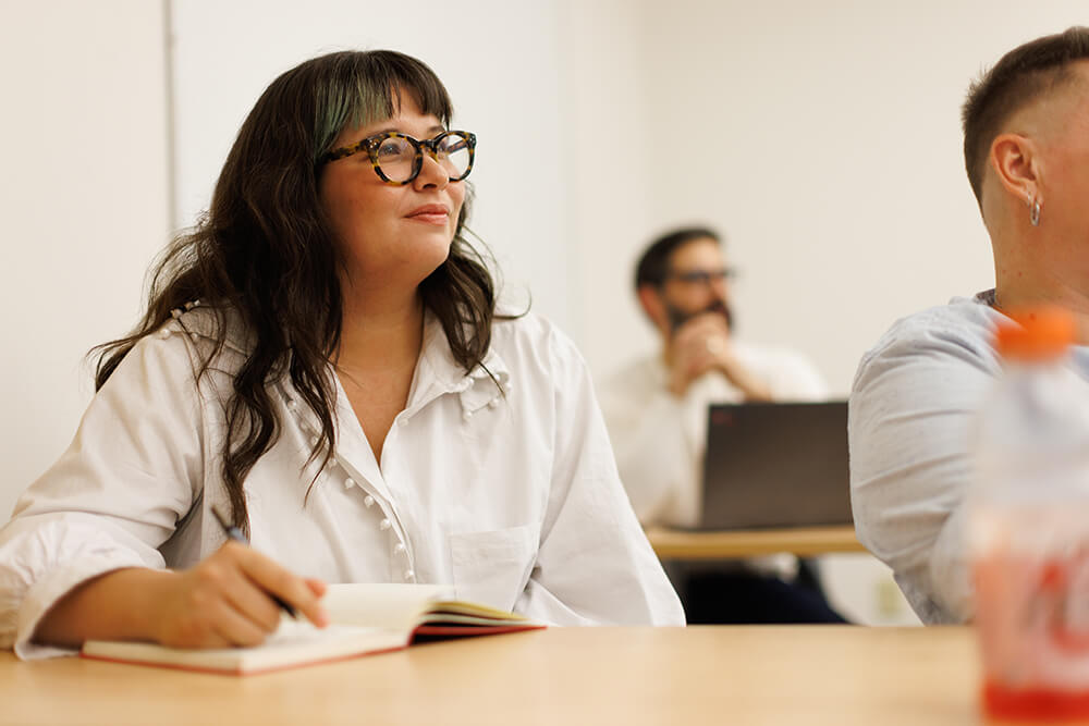 A psychology student smiles during class.